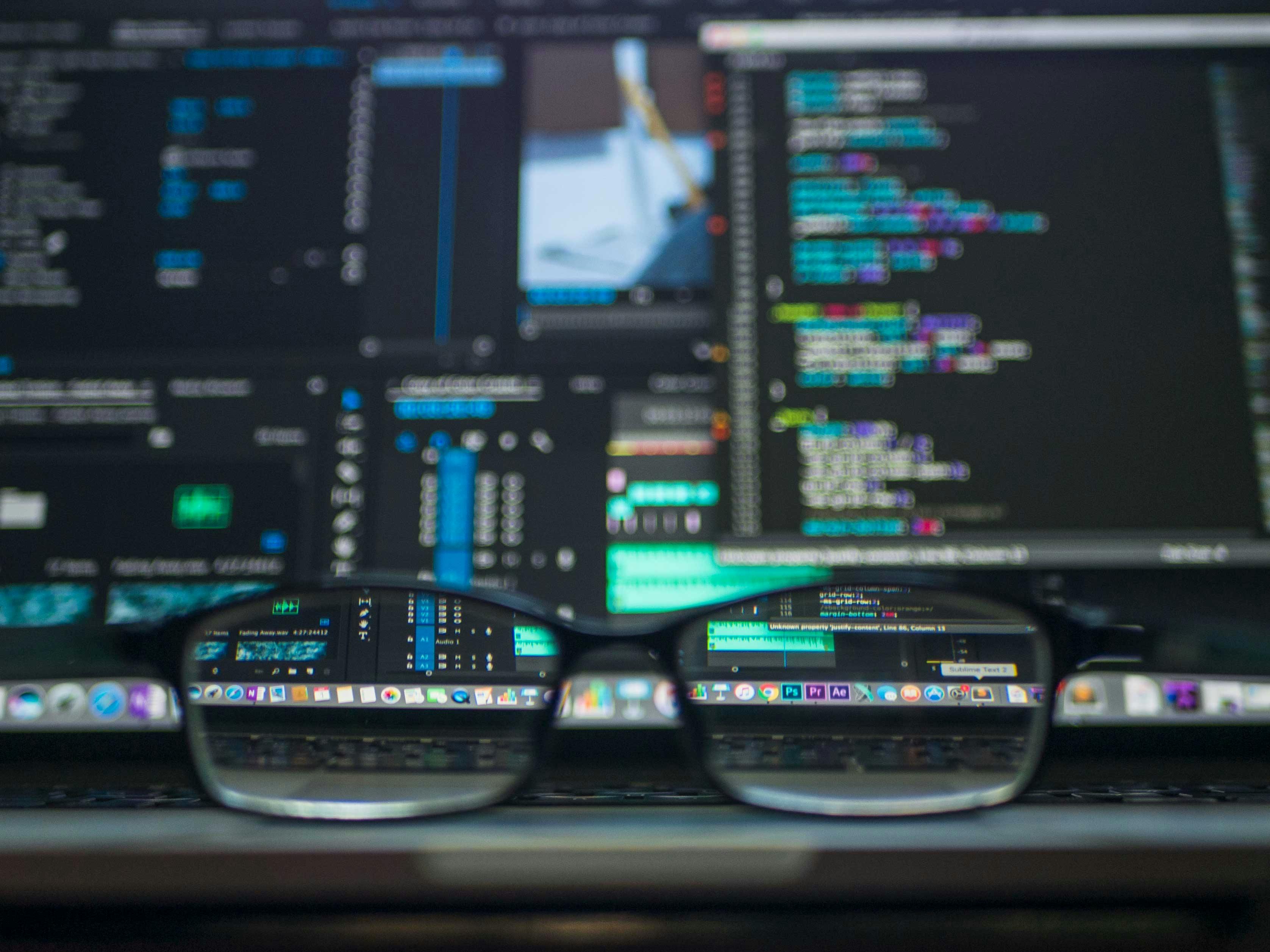 Glasses focusing on a small section of code, photo by Kevin Ku